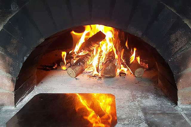 Custom Pizza Oven with fire burning