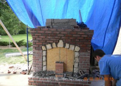 Outdoor Firebox rebuild and restoration in progress showing severely damaged masonry