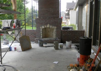 Outdoor Fireplace Chimney Rebuild in progress with mostly completed masonry