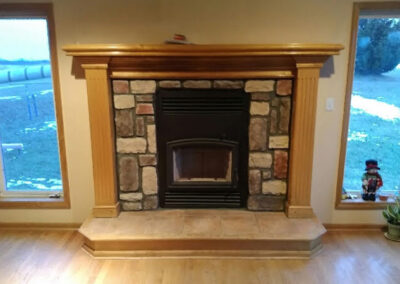 stone fireplace with a wood surround